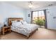 Tranquil bedroom with a wooden bed frame and balcony access, creating a relaxing retreat at 3261 S Sunland Dr, Chandler, AZ 85248