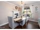 Bright dining room features a fireplace, chandelier, and large windows overlooking the backyard at 3261 S Sunland Dr, Chandler, AZ 85248