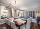 Elegant dining area with a chandelier, large windows, and ample seating, perfect for hosting gatherings and enjoying meals at 3261 S Sunland Dr, Chandler, AZ 85248