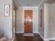 Inviting foyer features a wooden front door, hardwood floors, and neutral wall colors, creating a warm and welcoming entry at 3261 S Sunland Dr, Chandler, AZ 85248