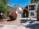 Charming two-story home boasts a stucco exterior, tile roof, and lush landscaping, including mature trees and flowering bushes at 3261 S Sunland Dr, Chandler, AZ 85248