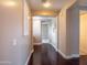 Hallway featuring dark wood floors and neutral walls with white trim, leading to various rooms at 3261 S Sunland Dr, Chandler, AZ 85248