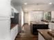 Bright kitchen boasts white cabinetry, stainless steel appliances, and a central island with dark cabinets at 3261 S Sunland Dr, Chandler, AZ 85248