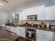 Well-equipped kitchen with stainless steel appliances, granite countertops, and white cabinetry for ample storage at 3261 S Sunland Dr, Chandler, AZ 85248