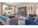 Cozy living room featuring a sofa, armchairs, display cabinet, and natural light, creating a comfortable and inviting atmosphere at 3261 S Sunland Dr, Chandler, AZ 85248