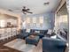 Spacious living room with a large sectional sofa, ceiling fan, and views to the kitchen and backyard at 3261 S Sunland Dr, Chandler, AZ 85248