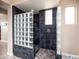 Elegant shower featuring dark tile and glass block partition for a modern and stylish design at 3261 S Sunland Dr, Chandler, AZ 85248