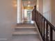 Carpeted stairs with wooden railings lead from one floor to another, showcasing the house's interior at 3261 S Sunland Dr, Chandler, AZ 85248