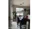Cozy dining area with a marble dining table, leather chairs, and sliding glass doors at 3825 S 60 Dr, Phoenix, AZ 85043