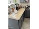 Close-up view of the kitchen counter with gray cabinets and appliances in a functional kitchen at 3825 S 60 Dr, Phoenix, AZ 85043