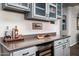Modern bar area features sleek countertops, gray cabinetry, and convenient wine cooler at 3830 N Red Sky Cir, Mesa, AZ 85207