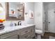 Modern bathroom featuring gray vanity with marble countertop and framed mirror at 3830 N Red Sky Cir, Mesa, AZ 85207