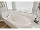 Bright bathroom featuring a soaking tub with white countertops and natural lighting at 3830 N Red Sky Cir, Mesa, AZ 85207