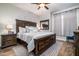 Spacious bedroom featuring a dark wood bed frame, ceiling fan, and a decorative rug at 3830 N Red Sky Cir, Mesa, AZ 85207