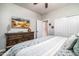 Bright bedroom featuring a bed with light blue bedding, ceiling fan, and a TV on dresser at 3830 N Red Sky Cir, Mesa, AZ 85207
