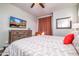 Comfortable bedroom featuring TV, dresser, and a bed with decorative pillows and coverings at 3830 N Red Sky Cir, Mesa, AZ 85207