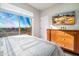 Bedroom with a large window offering a view, dresser, and wall-mounted TV at 3830 N Red Sky Cir, Mesa, AZ 85207