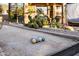 Bocce ball court adjacent to patio and lush desert landscaping at 3830 N Red Sky Cir, Mesa, AZ 85207