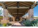 Inviting clubhouse entrance with stone pillars, desert landscaping, and a covered entryway at 3830 N Red Sky Cir, Mesa, AZ 85207