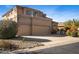 Charming two-story home featuring a three-car garage and desert landscaping at 3830 N Red Sky Cir, Mesa, AZ 85207