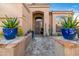 Inviting front entrance featuring a stone pathway and vibrant potted plants at 3830 N Red Sky Cir, Mesa, AZ 85207