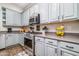Stylish kitchen featuring stainless steel appliances, gray cabinets, and modern hardware at 3830 N Red Sky Cir, Mesa, AZ 85207
