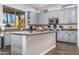 Modern kitchen with gray cabinets, stainless steel appliances, and a breakfast bar at 3830 N Red Sky Cir, Mesa, AZ 85207