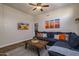 Comfortable living room featuring a large sectional sofa, wood coffee table, and desert-themed artwork at 3830 N Red Sky Cir, Mesa, AZ 85207