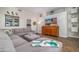 Cozy living room with a large gray sectional, media center, and plenty of natural light at 3830 N Red Sky Cir, Mesa, AZ 85207