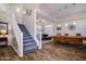 Spacious living room with hardwood floors, a staircase, and a pool table at 3830 N Red Sky Cir, Mesa, AZ 85207