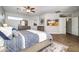 Bright main bedroom with wood-look floors, a ceiling fan, a comfortable bed, and ample dresser storage at 3830 N Red Sky Cir, Mesa, AZ 85207