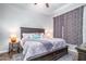 Comfortable main bedroom features a wooden headboard, patterned bedding, and bedside lamps at 3830 N Red Sky Cir, Mesa, AZ 85207