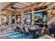 Covered patio dining area with large table, chairs, and views of the backyard at 3830 N Red Sky Cir, Mesa, AZ 85207