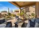 Comfortable covered patio with seating, lush landscaping, and spiral staircase at 3830 N Red Sky Cir, Mesa, AZ 85207