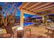 Charming covered patio with outdoor seating, a fire pit, and a view of the pool at 3830 N Red Sky Cir, Mesa, AZ 85207