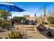 Inviting outdoor patio with seating area surrounded by desert landscaping at 3830 N Red Sky Cir, Mesa, AZ 85207
