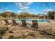 Sparkling community pool with lounge chairs, perfect for enjoying sunny days and relaxation at 3830 N Red Sky Cir, Mesa, AZ 85207