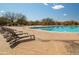 Stunning community pool with lap lanes and plenty of lounge seating for relaxing by the water at 3830 N Red Sky Cir, Mesa, AZ 85207