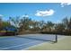 Well-maintained tennis court with blue and green surface, providing a great recreational amenity at 3830 N Red Sky Cir, Mesa, AZ 85207
