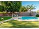 Lush backyard oasis with a sparkling pool, lounge chairs, and a putting green for outdoor enjoyment at 4030 E Prickly Pear Trl, Phoenix, AZ 85050