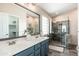 Bathroom with dual sinks, a framed mirror and a large glass shower enclosure at 4030 E Prickly Pear Trl, Phoenix, AZ 85050