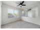 Bright bedroom featuring a modern ceiling fan, neutral carpet, and a window with bright natural light at 4030 E Prickly Pear Trl, Phoenix, AZ 85050