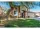 Charming two-story home with a well-manicured lawn, mature tree, and welcoming entrance at 4030 E Prickly Pear Trl, Phoenix, AZ 85050