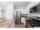 Chef's kitchen featuring stainless appliances, granite counters, and white cabinetry at 4030 E Prickly Pear Trl, Phoenix, AZ 85050