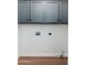 Laundry room area with blue cabinets, hookups for machines, and tile flooring at 4030 E Prickly Pear Trl, Phoenix, AZ 85050
