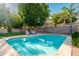 Beautiful backyard with a refreshing pool, lounge chairs, and mature trees for shade at 4030 E Prickly Pear Trl, Phoenix, AZ 85050