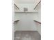 Empty walk-in closet with carpeted floor and wooden closet rods at 4030 E Prickly Pear Trl, Phoenix, AZ 85050