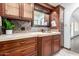 Bathroom vanity with dark wood cabinets, tile backsplash, and stone countertop at 4556 E Paradise Ln, Phoenix, AZ 85032