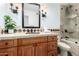 Bathroom with beautiful vanity with stone countertop and dark wood cabinets at 4556 E Paradise Ln, Phoenix, AZ 85032