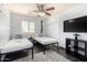 Bright bedroom features a ceiling fan, closet, and PLAY wall decor at 4556 E Paradise Ln, Phoenix, AZ 85032